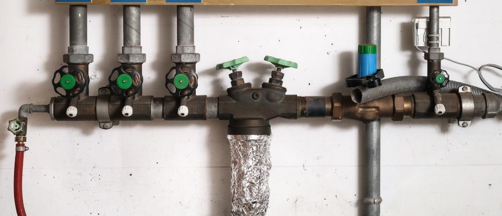Group of backwater valve or backflow shut off valve in service room of building.