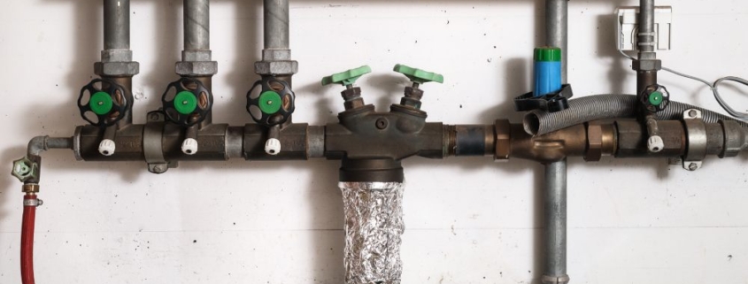 Group of backwater valve or backflow shut off valve in service room of building.