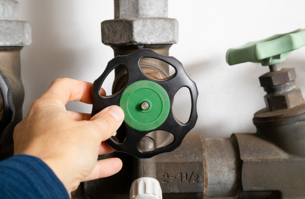 Plumber using backflow shut off valve or backwater valve.