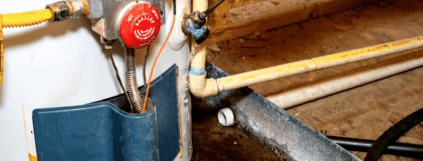 A technician repairing a residential electric water heater in a utility room.